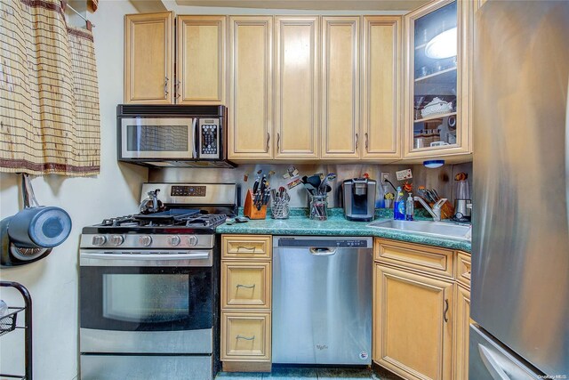 kitchen with light brown cabinets, sink, and appliances with stainless steel finishes