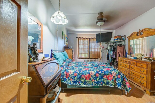 bedroom featuring hardwood / wood-style flooring, ceiling fan, and a closet