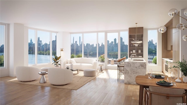 sunroom with a water view, a healthy amount of sunlight, and sink