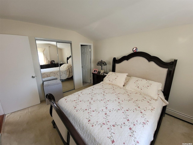 bedroom with baseboard heating, two closets, light colored carpet, and lofted ceiling