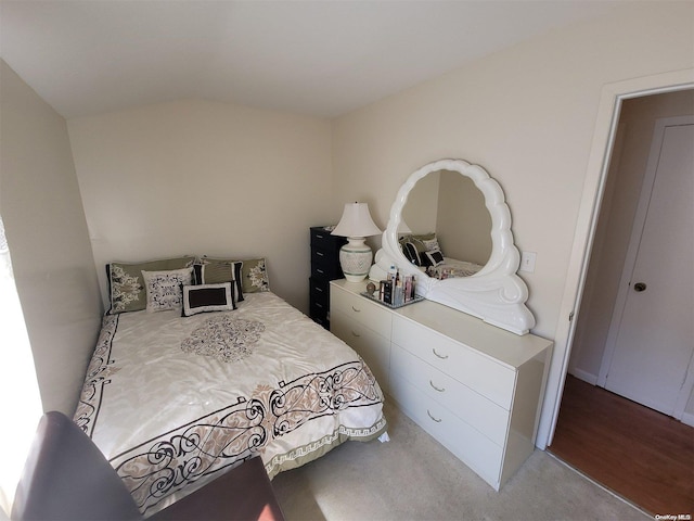 carpeted bedroom with vaulted ceiling