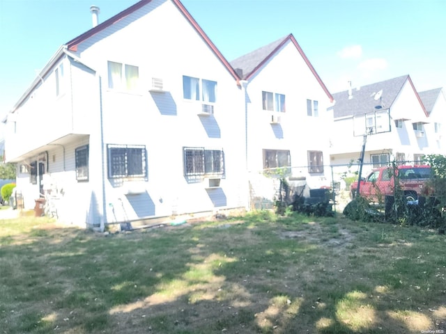 back of house featuring a yard