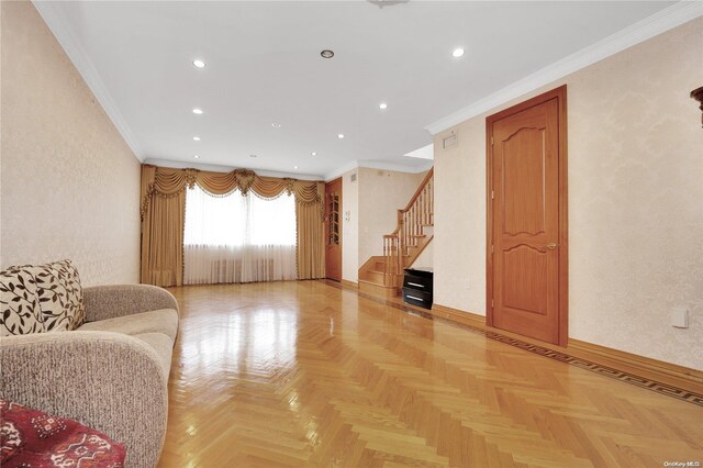 unfurnished living room featuring crown molding and light parquet floors