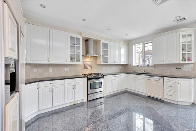 kitchen featuring white dishwasher, wall chimney exhaust hood, gas stove, and white cabinetry