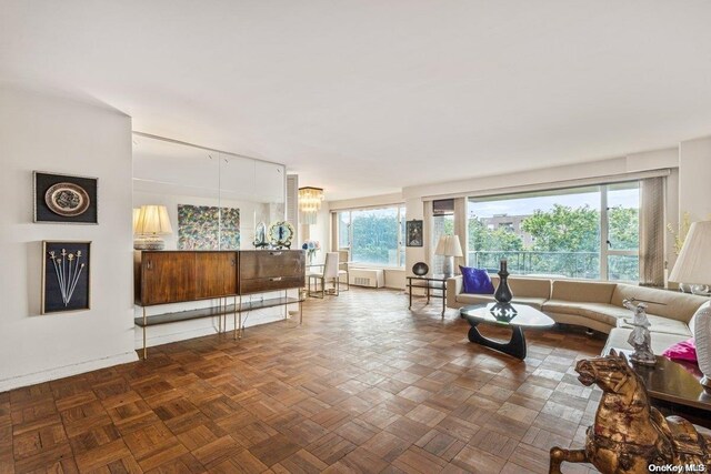 living room featuring parquet flooring and radiator