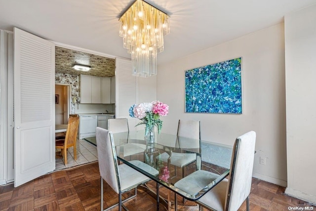 dining space with dark parquet floors and a notable chandelier