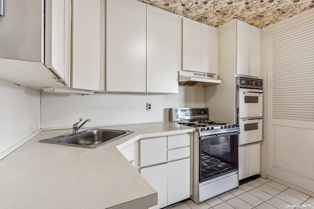 kitchen with white cabinetry, light tile patterned flooring, white appliances, and sink