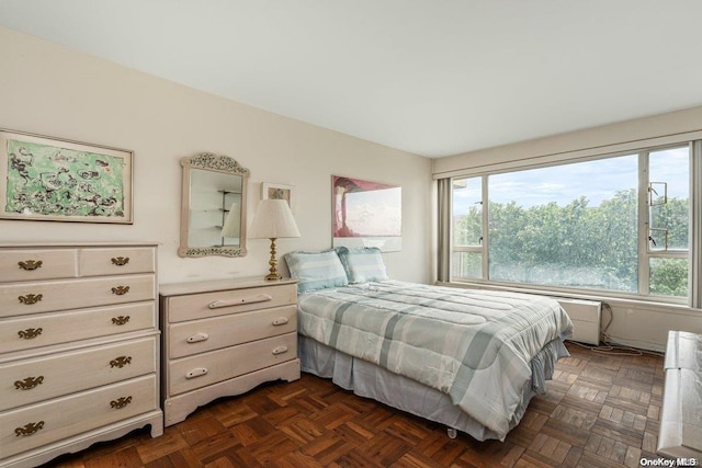 bedroom with dark parquet flooring