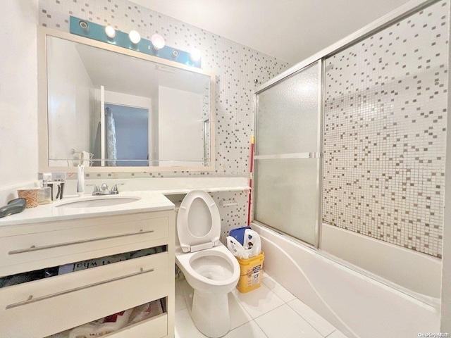 full bathroom with toilet, vanity, tile patterned floors, and shower / bath combination with glass door