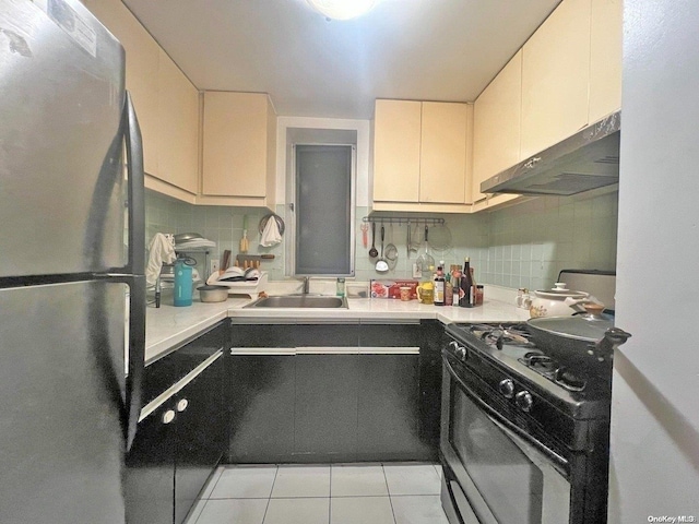 kitchen featuring stainless steel fridge, black range oven, extractor fan, sink, and light tile patterned floors