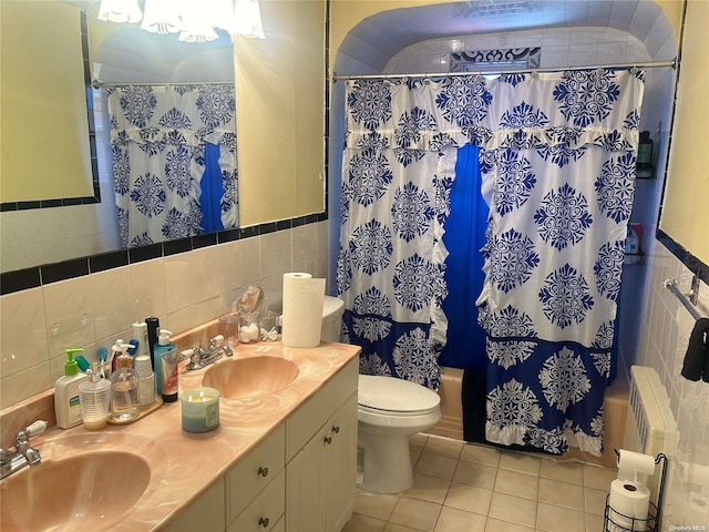 full bathroom featuring radiator, tile patterned floors, toilet, shower / tub combo with curtain, and tile walls