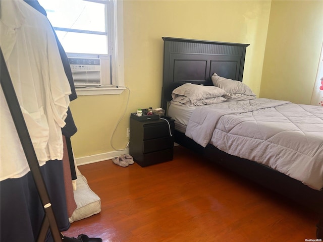 bedroom featuring hardwood / wood-style floors and cooling unit