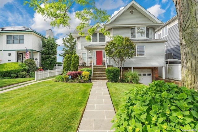 view of front of property featuring a front yard and a garage