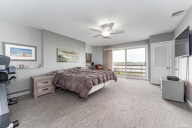 carpeted bedroom with access to outside, ceiling fan, and a baseboard heating unit