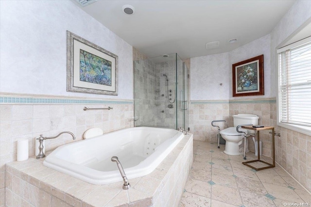 bathroom featuring shower with separate bathtub, tile walls, and toilet