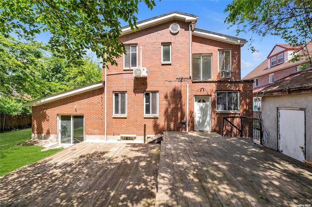 rear view of property with a deck and a wall unit AC