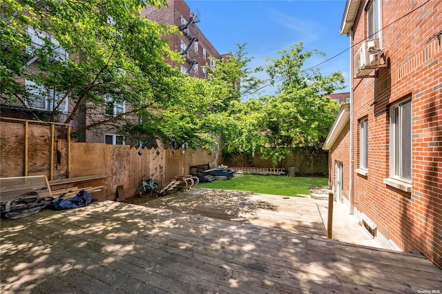 wooden terrace featuring a lawn