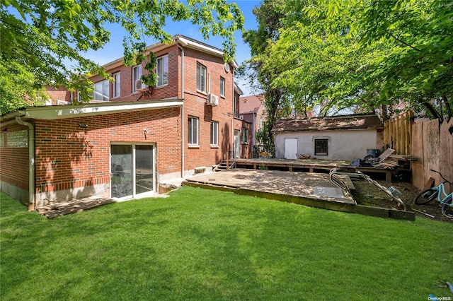 rear view of property featuring a patio area, a yard, and a deck