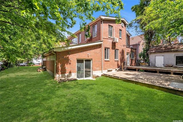 back of house featuring a wooden deck and a yard