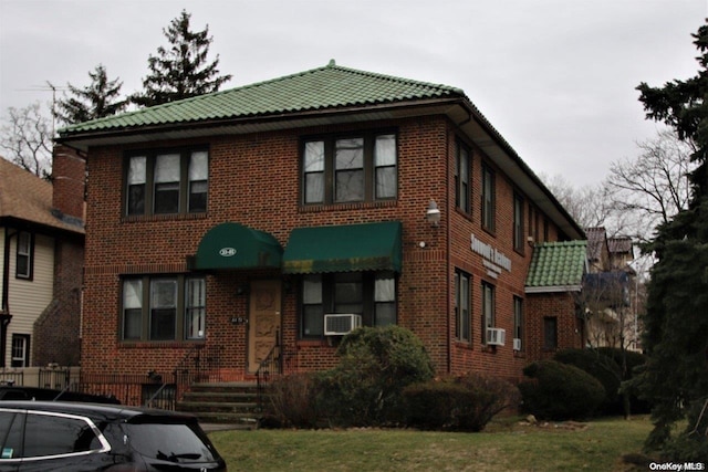 view of front of home featuring a front yard and cooling unit