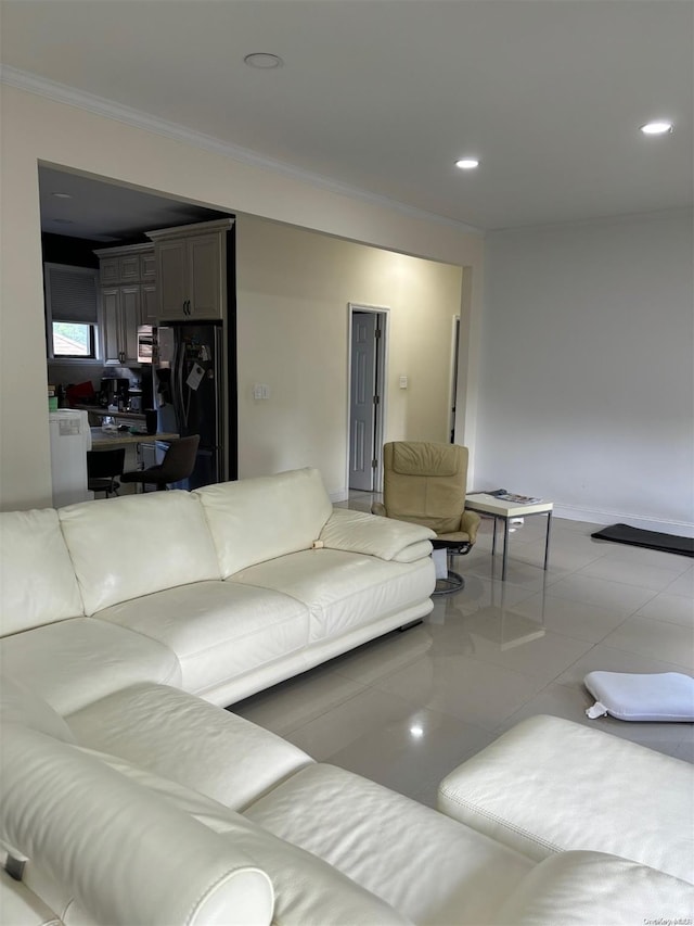 living room featuring light tile patterned floors and crown molding