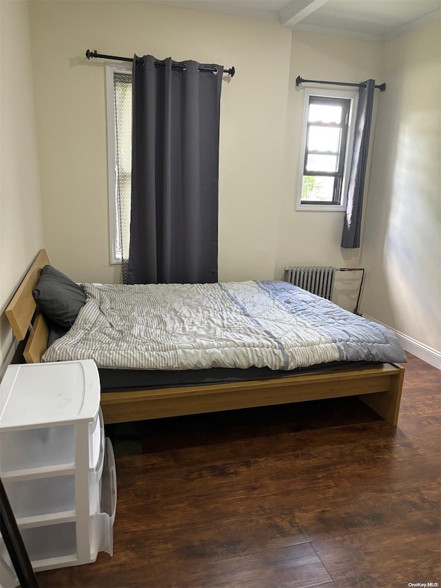 bedroom featuring dark wood-type flooring and radiator