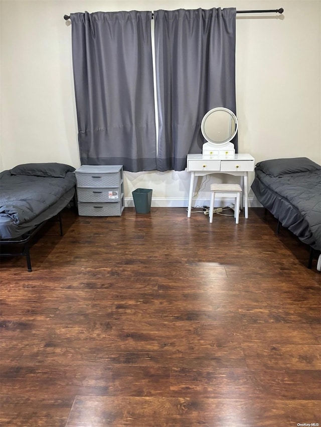 bedroom with dark hardwood / wood-style flooring