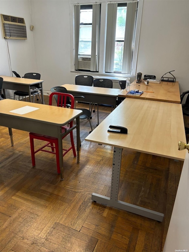 office space featuring dark parquet floors, a wall mounted AC, and cooling unit