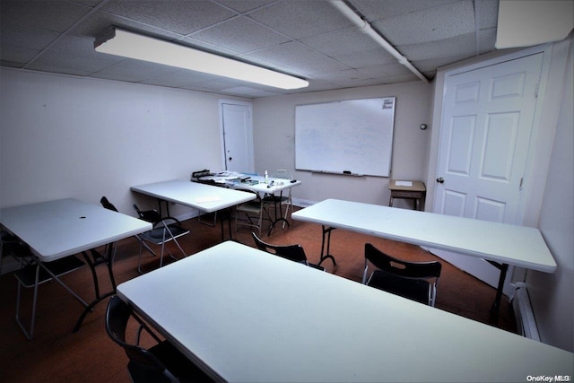 office area featuring a paneled ceiling and hardwood / wood-style flooring