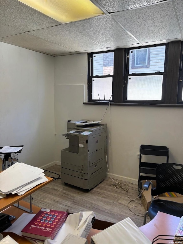 office space with a drop ceiling and hardwood / wood-style flooring