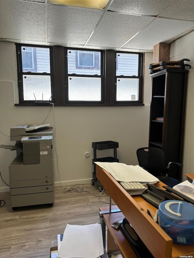 home office featuring a paneled ceiling and hardwood / wood-style flooring