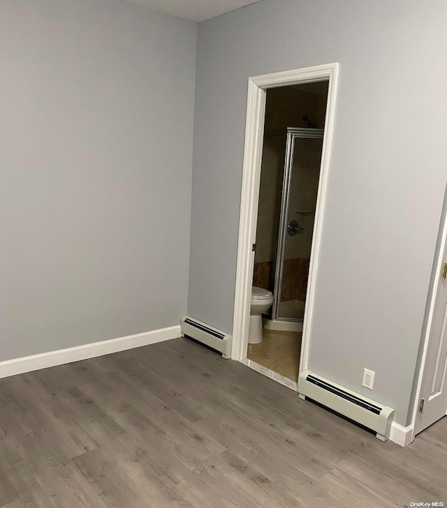 spare room with light hardwood / wood-style floors and baseboard heating