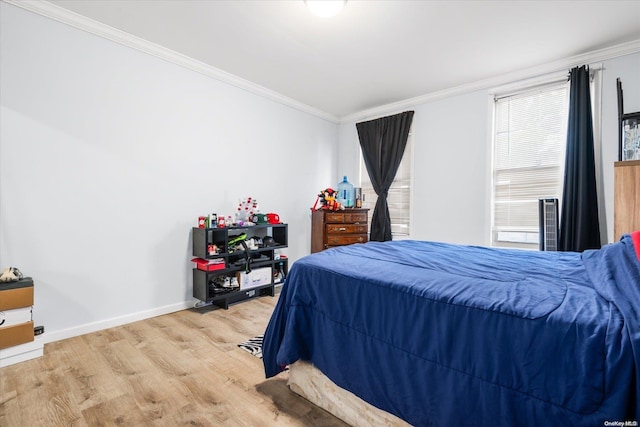 bedroom featuring hardwood / wood-style floors and ornamental molding