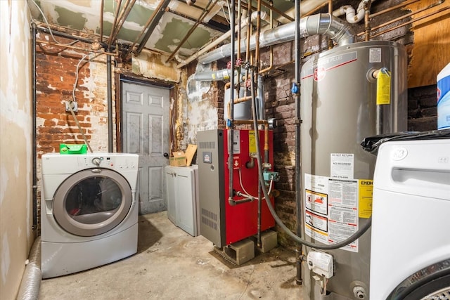 washroom with washer and clothes dryer, gas water heater, and brick wall