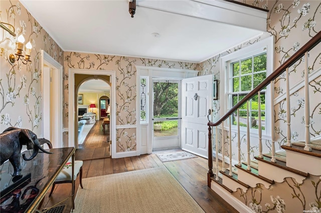 200 Cleft Rd, Mill Neck, NY 11765 - foyer featuring wallpapered walls, hardwood / wood-style flooring, healthy amount of natural light, arched walkways, and stairway