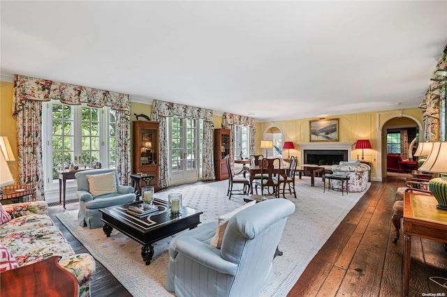 living room featuring hardwood / wood-style floors, french doors, and ornamental molding