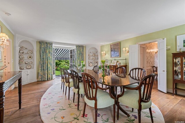 200 Cleft Rd, Mill Neck, NY 11765 - dining space featuring built in shelves, hardwood / wood-style flooring, crown molding, and a chandelier