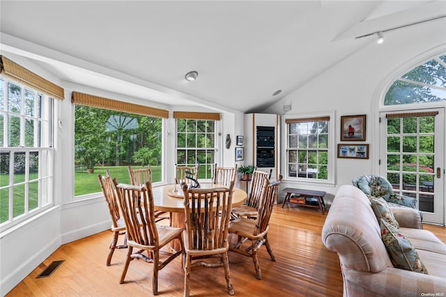 dining area featuring light hardwood / wood-style flooring and lofted ceiling