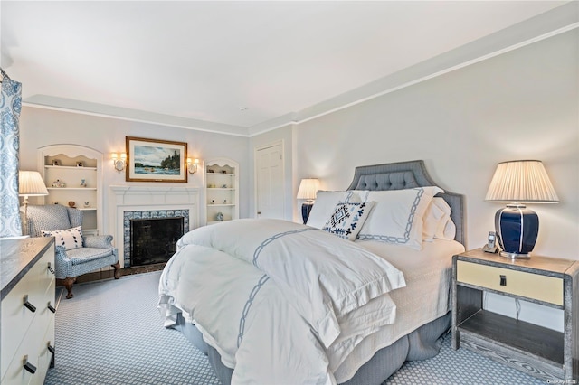 bedroom featuring light carpet, crown molding, and a premium fireplace