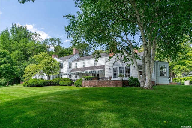 200 Cleft Rd, Mill Neck, NY 11765 - view of front facade with a front lawn and a chimney