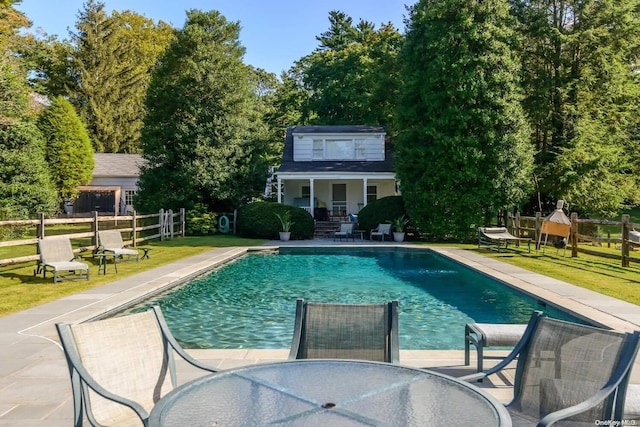 view of swimming pool featuring a yard and a patio