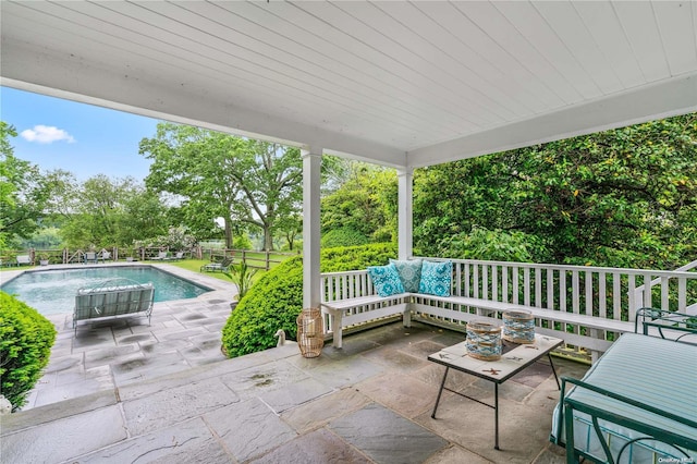 view of patio featuring pool water feature, an outdoor living space, and a fenced in pool