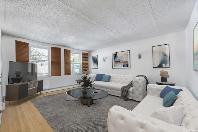 living room featuring hardwood / wood-style floors, a textured ceiling, and a baseboard heating unit