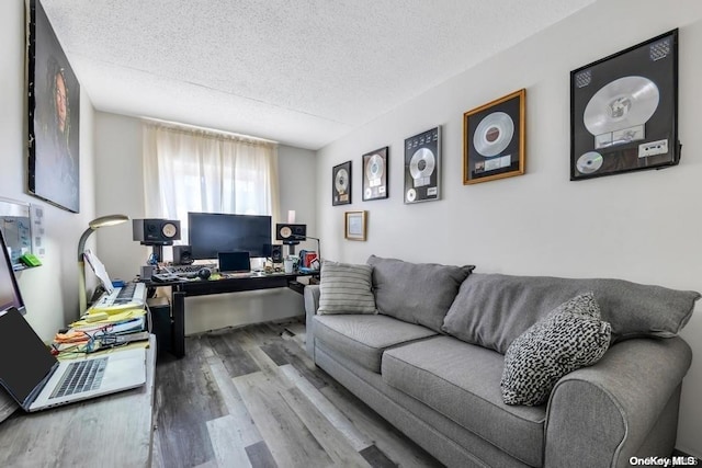 office space with light hardwood / wood-style flooring and a textured ceiling