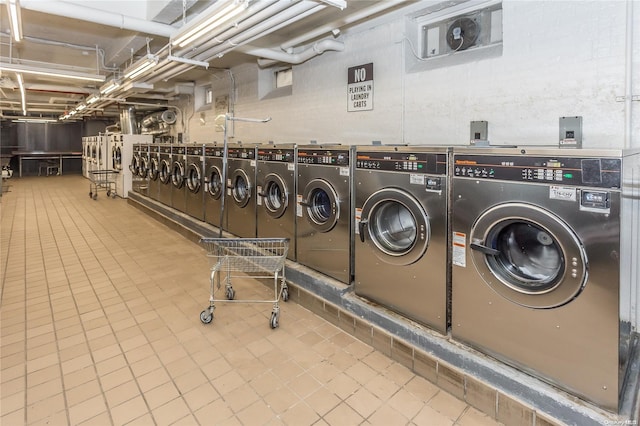 laundry room featuring tile patterned floors and washing machine and dryer