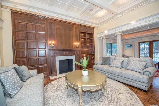 living room featuring beam ceiling, coffered ceiling, a premium fireplace, decorative columns, and ornamental molding