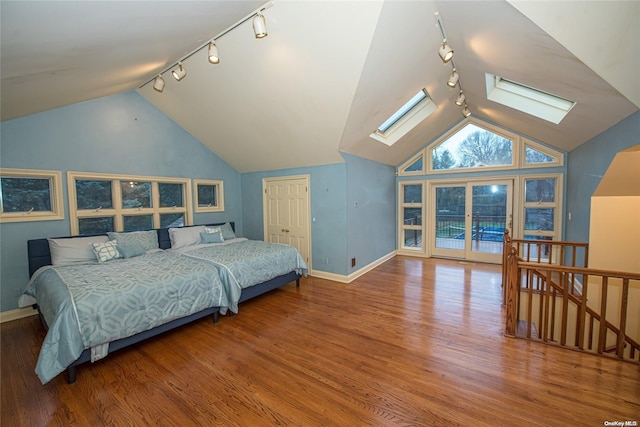 bedroom with a closet, track lighting, and hardwood / wood-style flooring