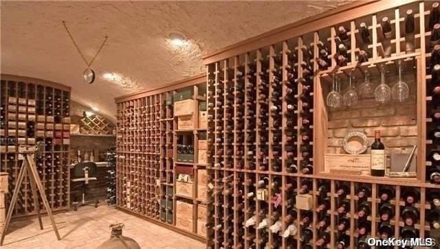 wine area featuring a textured ceiling