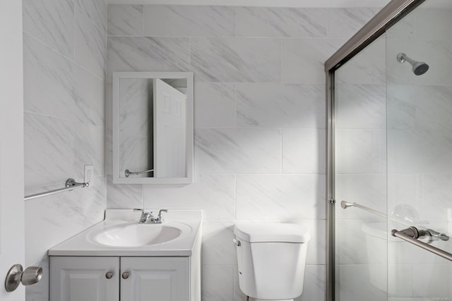 bathroom featuring vanity, toilet, and a shower with shower door