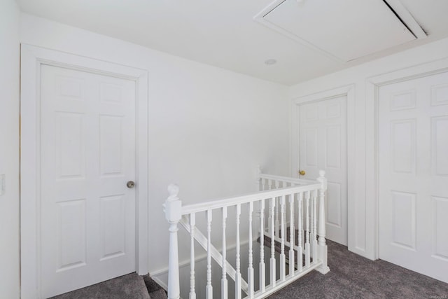 hallway featuring dark colored carpet